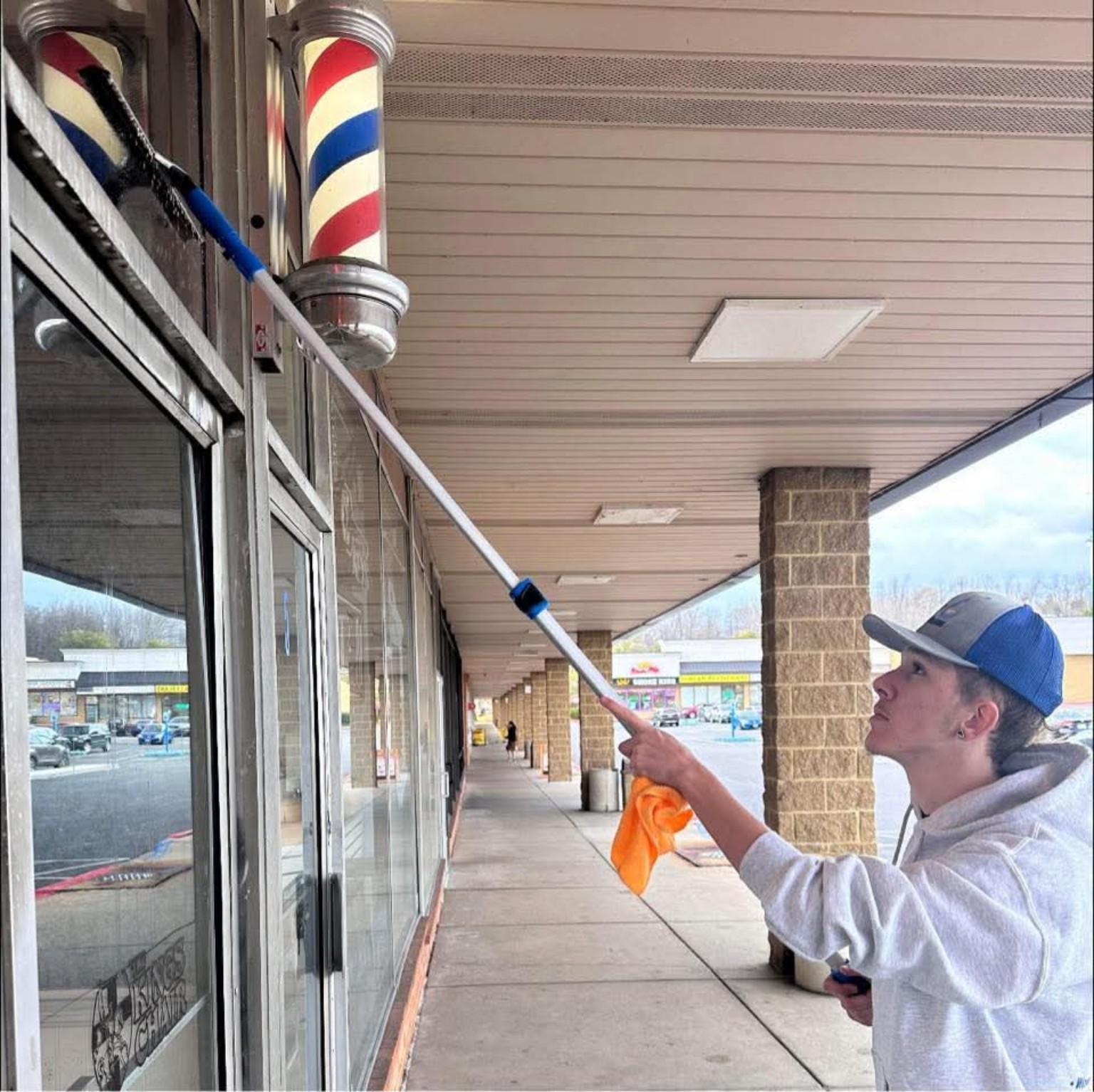 Shaun cleaning commercial storefront glass